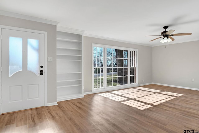 entryway featuring ceiling fan, wood-type flooring, and crown molding