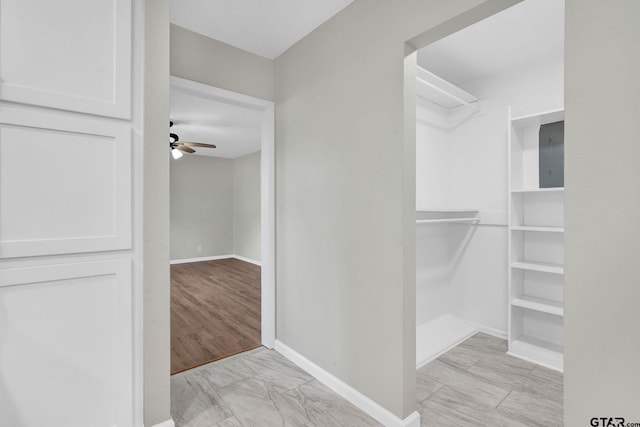 walk in closet with ceiling fan