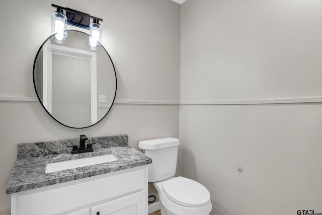 bathroom with toilet and vanity