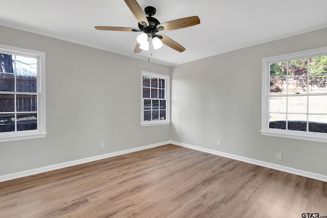 empty room featuring light hardwood / wood-style floors, plenty of natural light, and ceiling fan