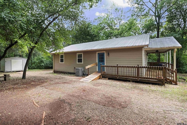 321 Inwood, Bullard, TX 75757 - back of property with central AC unit, metal roof, an outbuilding, and a shed