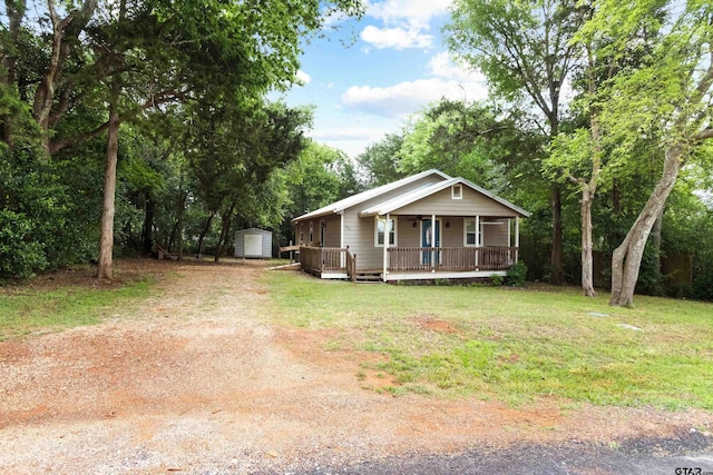 321 Inwood, Bullard, TX 75757 - bungalow-style home featuring driveway, an outdoor structure, a porch, a front lawn, and a storage unit