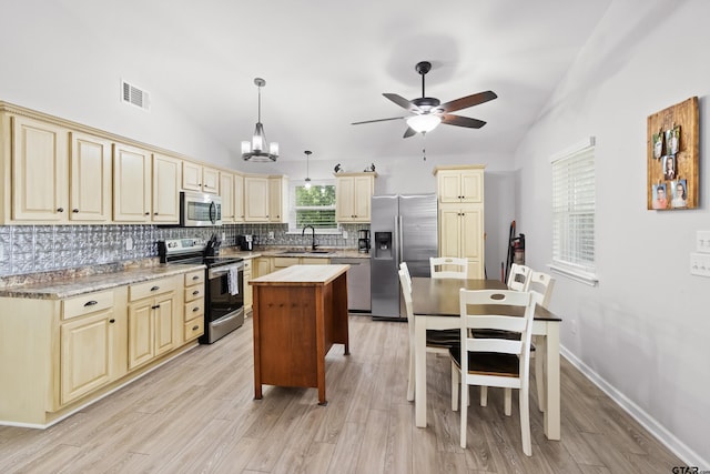 321 Inwood, Bullard, TX 75757 - kitchen featuring lofted ceiling, visible vents, a sink, cream cabinetry, and stainless steel appliances