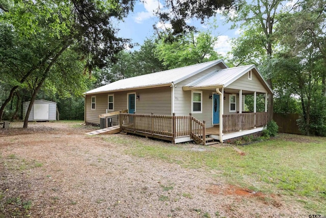 321 Inwood, Bullard, TX 75757 - view of front of house with fence, metal roof, a front yard, a shed, and an outbuilding