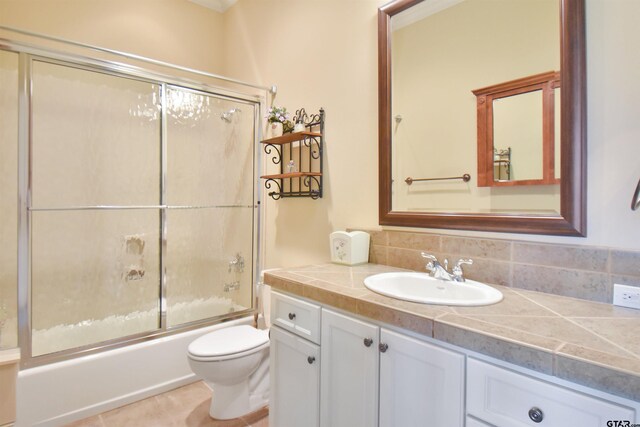1860 Holcomb Cir, Tyler, TX 75703 - full bathroom featuring tile patterned flooring, toilet, decorative backsplash, combined bath / shower with glass door, and vanity
