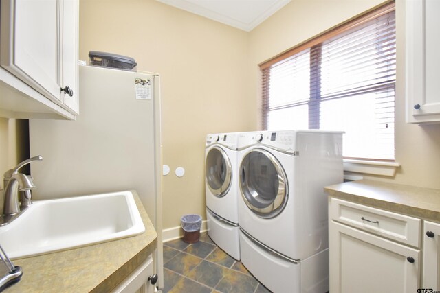 1860 Holcomb Cir, Tyler, TX 75703 - clothes washing area with baseboards, cabinet space, ornamental molding, a sink, and washer and dryer