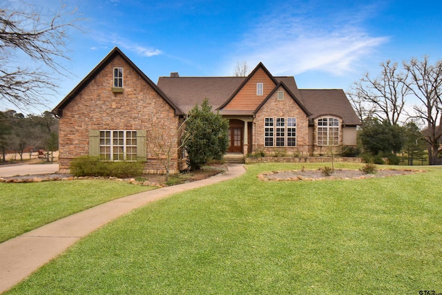 1860 Holcomb Cir, Tyler, TX 75703 - view of front facade featuring a front lawn, stone siding, and a chimney