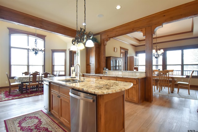 1860 Holcomb Cir, Tyler, TX 75703 - kitchen with a sink, brown cabinetry, stainless steel dishwasher, and a chandelier