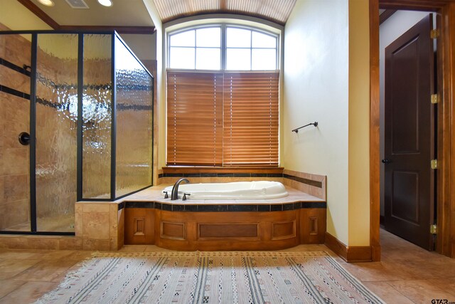 1860 Holcomb Cir, Tyler, TX 75703 - full bathroom featuring tile patterned floors, baseboards, a garden tub, and a shower stall