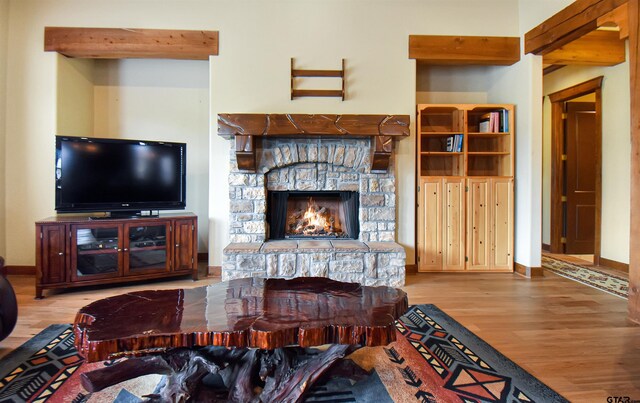 1860 Holcomb Cir, Tyler, TX 75703 - living room featuring a stone fireplace, baseboards, and wood finished floors