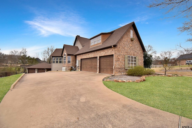 1860 Holcomb Cir, Tyler, TX 75703 - view of front of house featuring stone siding, cooling unit, concrete driveway, an attached garage, and a front yard