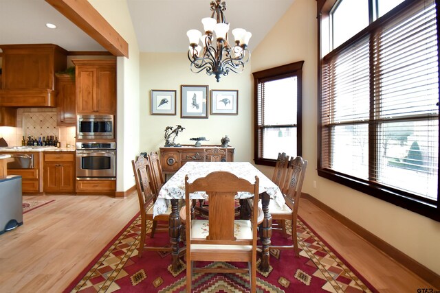 1860 Holcomb Cir, Tyler, TX 75703 - dining space featuring an inviting chandelier, vaulted ceiling, baseboards, and light wood-type flooring