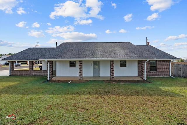 rear view of property with a yard