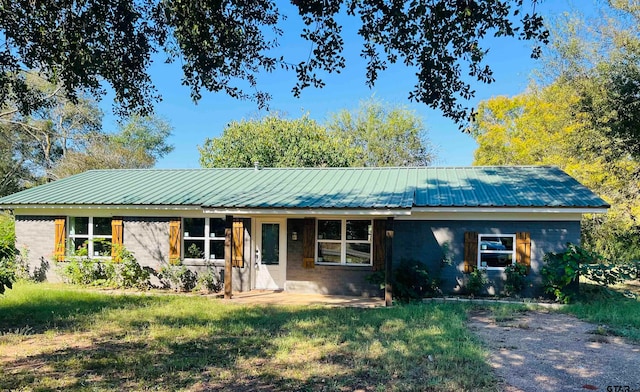 ranch-style home with a front lawn