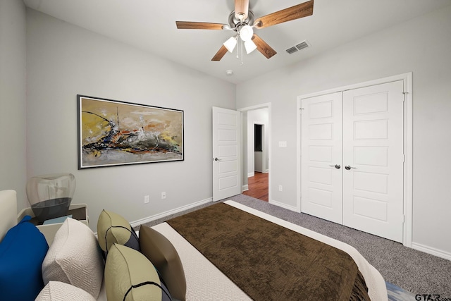 carpeted bedroom featuring a ceiling fan, baseboards, visible vents, and a closet