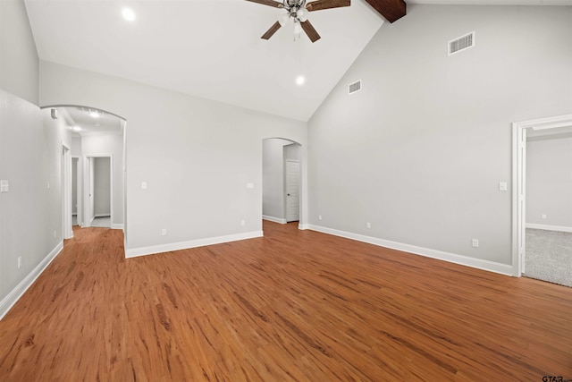 unfurnished bedroom with visible vents, arched walkways, recessed lighting, and high vaulted ceiling