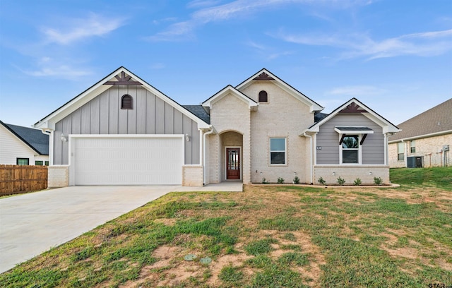 ranch-style home featuring board and batten siding, a garage, brick siding, fence, and concrete driveway