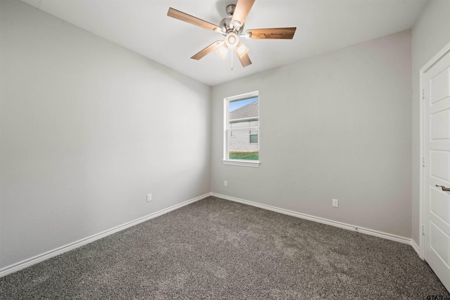 spare room with carpet floors, a ceiling fan, and baseboards