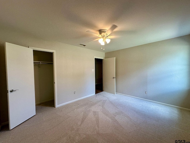 unfurnished bedroom featuring a closet, ceiling fan, carpet floors, and baseboards