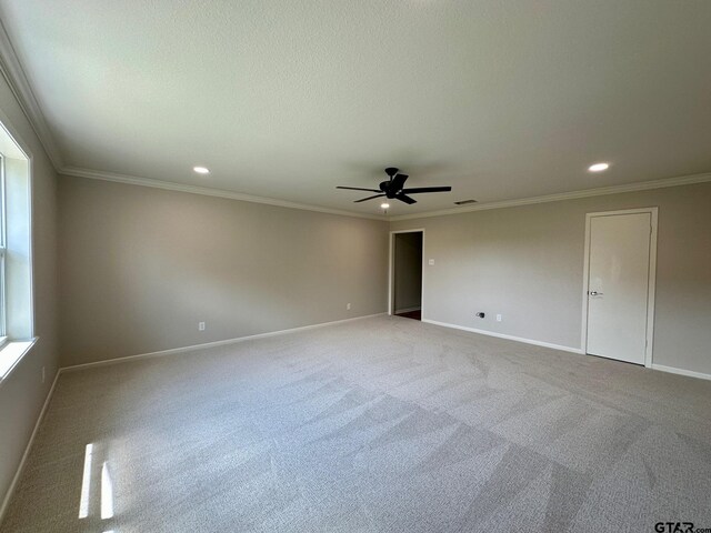 carpeted spare room featuring baseboards, recessed lighting, a ceiling fan, and crown molding