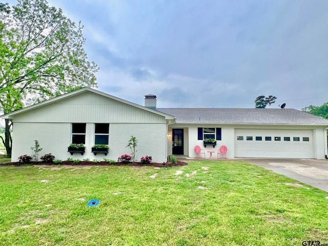 ranch-style house with a chimney, brick siding, a front yard, concrete driveway, and an attached garage