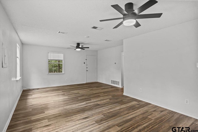 empty room with ceiling fan, a textured ceiling, and dark hardwood / wood-style flooring