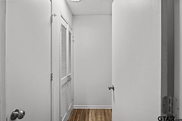 interior space with dark hardwood / wood-style floors and a textured ceiling