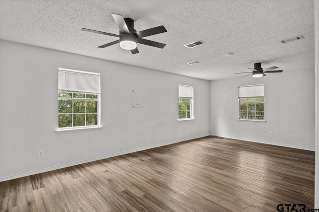 empty room featuring hardwood / wood-style floors, a textured ceiling, and ceiling fan