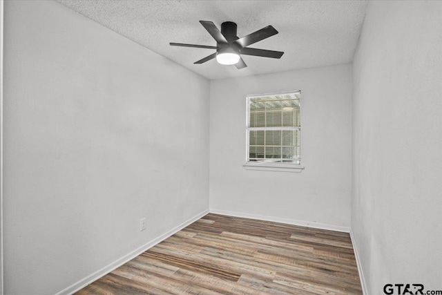 empty room featuring a textured ceiling, hardwood / wood-style flooring, and ceiling fan