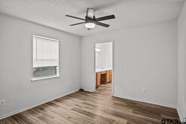 unfurnished room featuring ceiling fan, a textured ceiling, and light hardwood / wood-style floors