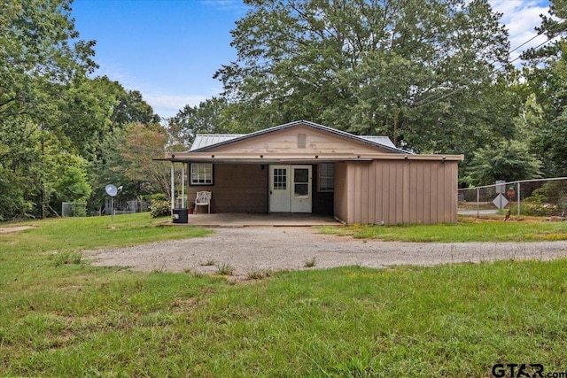 view of outbuilding with a yard and a carport