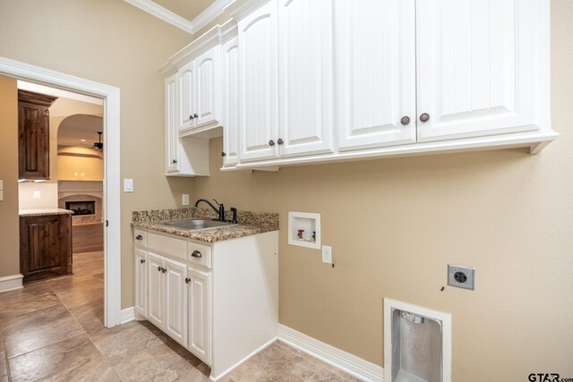 936 Cambridge Bnd, Tyler, TX 75703 - laundry area with cabinet space, electric dryer hookup, hookup for a washing machine, a fireplace, and ornamental molding