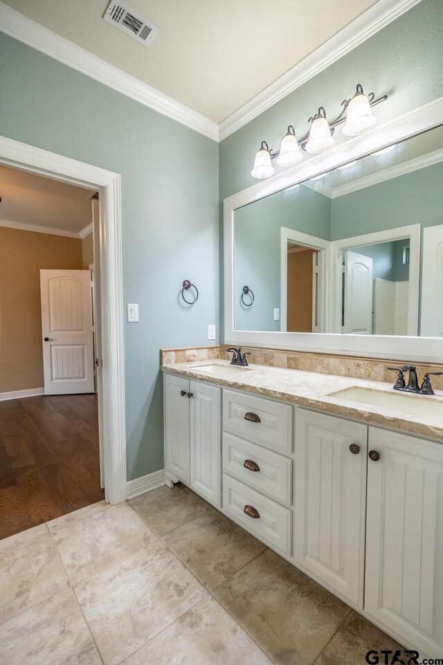 936 Cambridge Bnd, Tyler, TX 75703 - bathroom featuring crown molding, double vanity, and baseboards