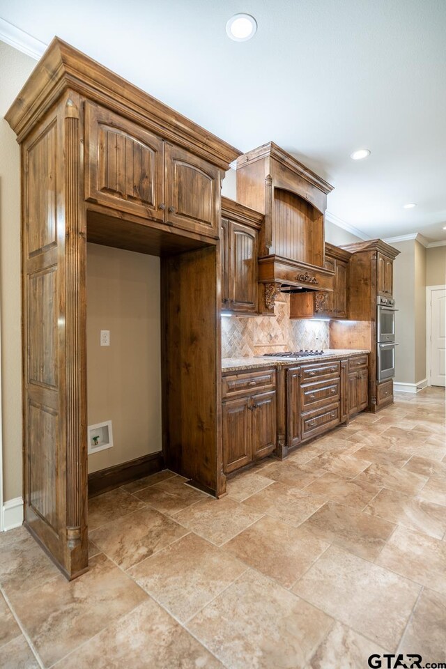 936 Cambridge Bnd, Tyler, TX 75703 - kitchen with crown molding, baseboards, decorative backsplash, recessed lighting, and light stone finish floors