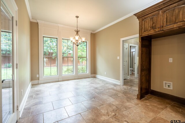 936 Cambridge Bnd, Tyler, TX 75703 - unfurnished dining area featuring a chandelier, baseboards, stone tile flooring, and ornamental molding