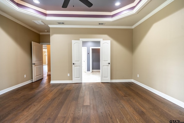936 Cambridge Bnd, Tyler, TX 75703 - unfurnished bedroom featuring a tray ceiling, crown molding, dark wood-type flooring, and baseboards