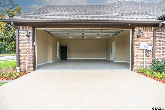 936 Cambridge Bnd, Tyler, TX 75703 - garage with concrete driveway and a garage door opener