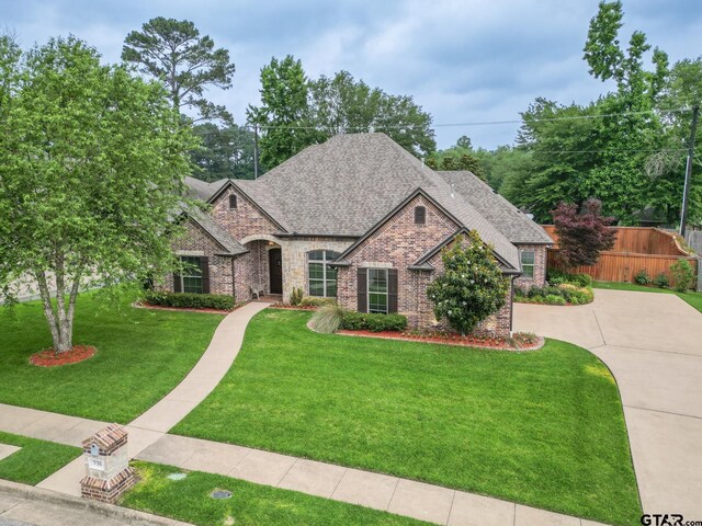 936 Cambridge Bnd, Tyler, TX 75703 - french country inspired facade featuring brick siding, a shingled roof, driveway, and stone siding