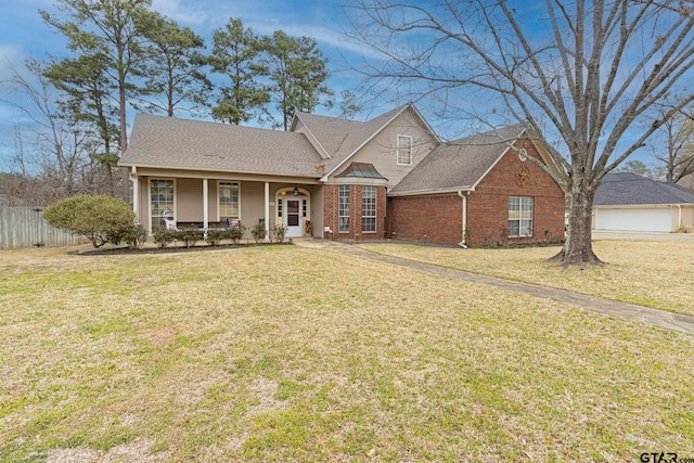 view of front of home with a front yard and covered porch