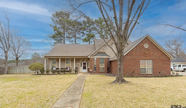 view of front of house with a porch and a front lawn