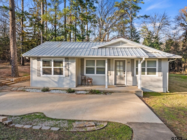 view of front of house featuring a porch and metal roof