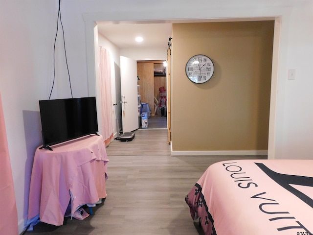 bedroom with baseboards and wood finished floors