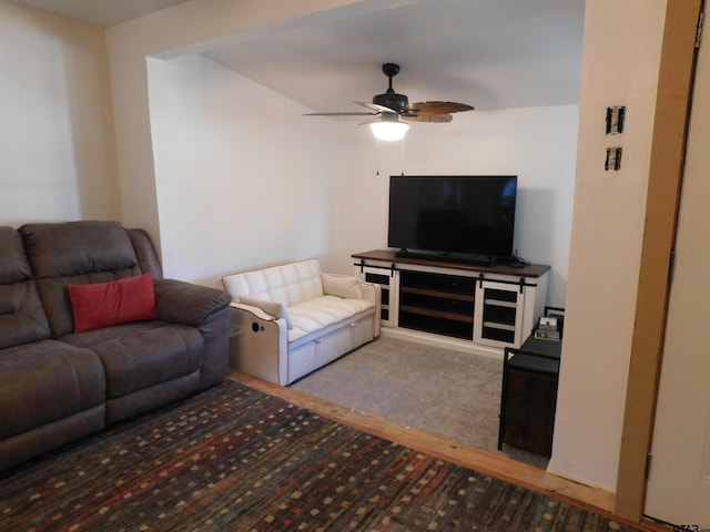 living room with a ceiling fan and carpet floors