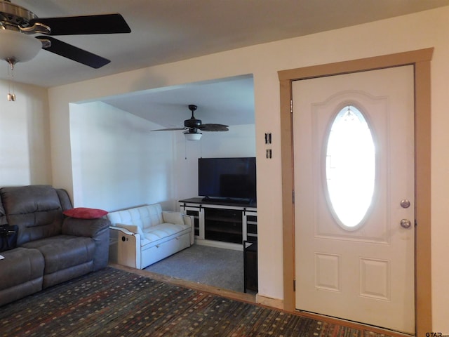 carpeted entrance foyer featuring a ceiling fan