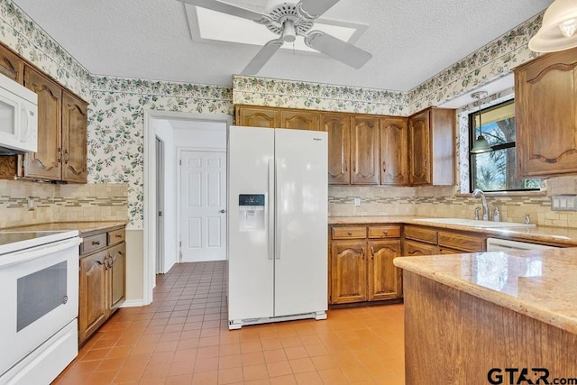 kitchen with white appliances, sink, a textured ceiling, and backsplash