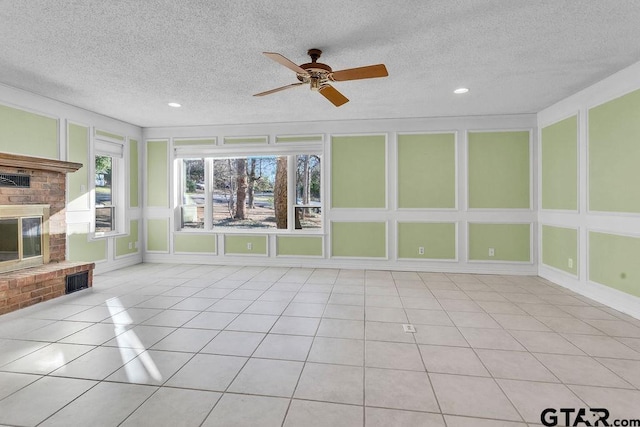 unfurnished sunroom featuring a brick fireplace and ceiling fan