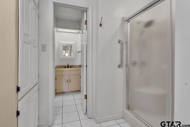 bathroom with tile patterned floors, an enclosed shower, and vanity