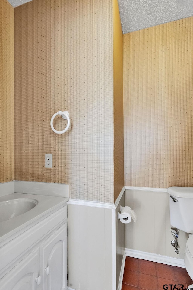 bathroom with vanity, tile patterned floors, a textured ceiling, and toilet