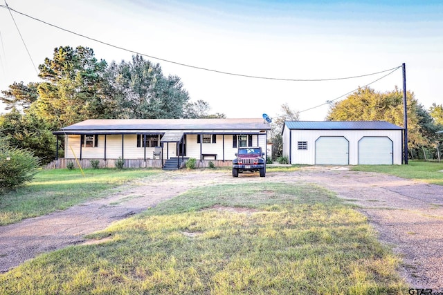 ranch-style house featuring an outbuilding, a garage, and a front lawn