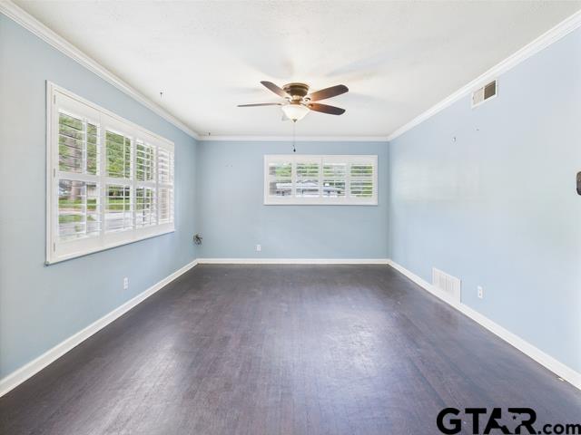 3323 S Keaton Ave, Tyler, TX 75701 - empty room with ornamental molding, a ceiling fan, wood finished floors, and a wealth of natural light